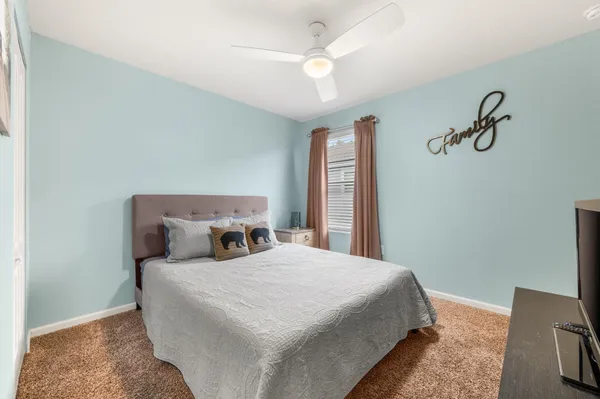 a bedroom with a bed and a chandelier
