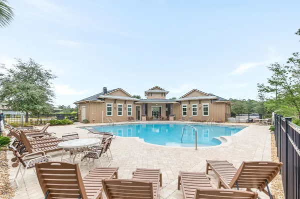 a view of a house with patio and a yard