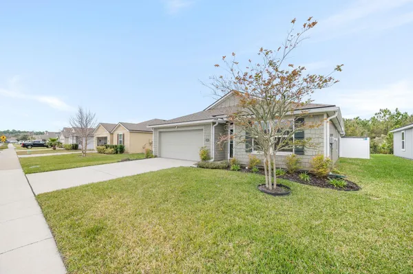 a view of a house with a backyard