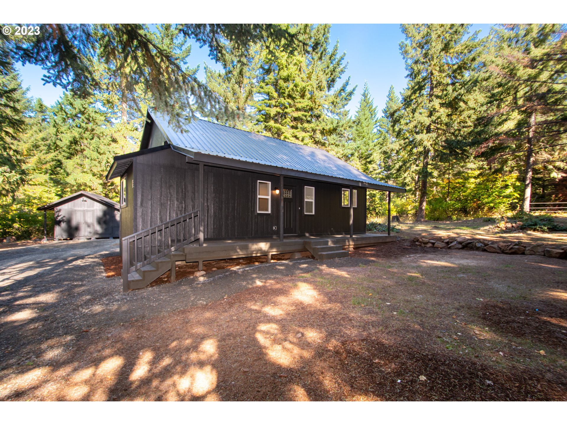 a view of a house with a yard and tree