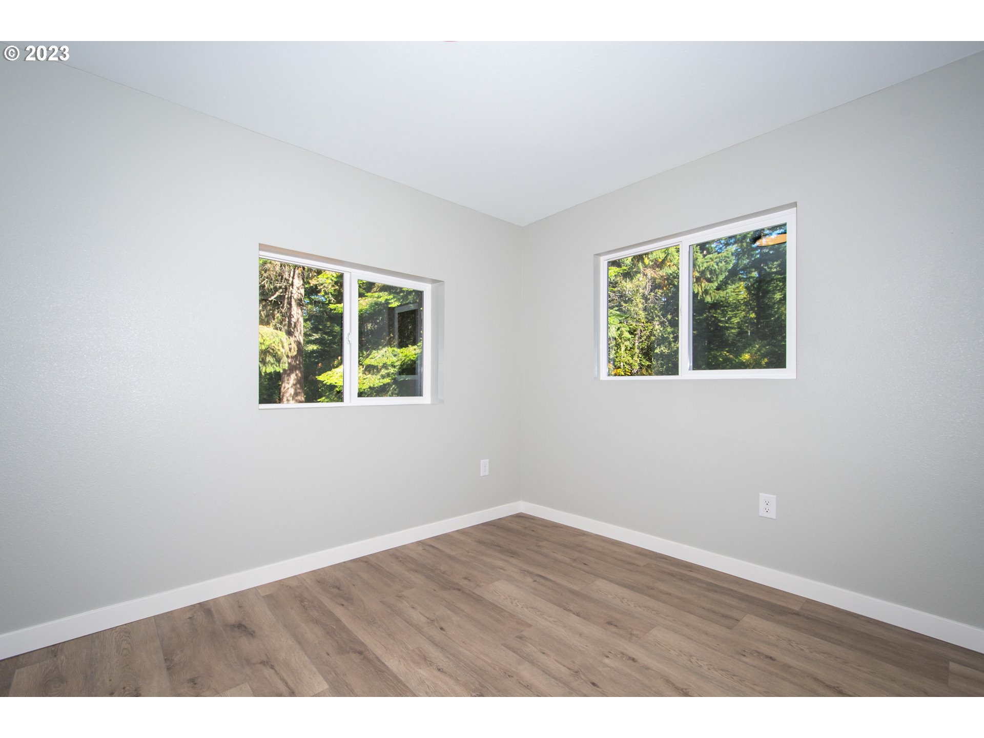 55 Moonshine Road Appleton, WA 98602 - Photo 13 of 33 an empty room with wooden floor and windows