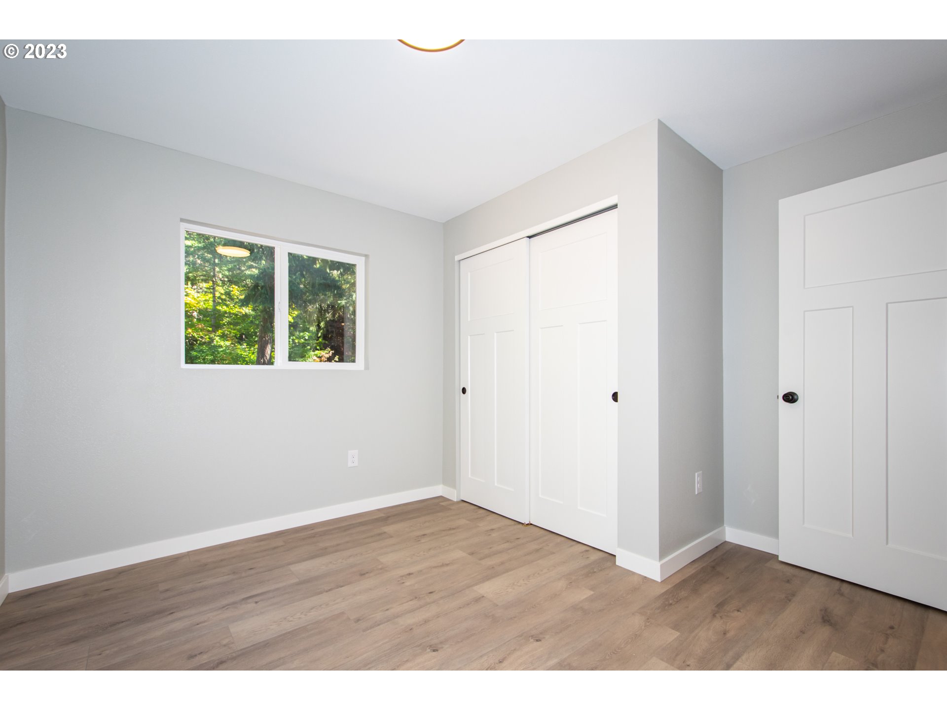 55 Moonshine Road Appleton, WA 98602 - Photo 14 of 33 a view of an empty room with wooden floor and a window