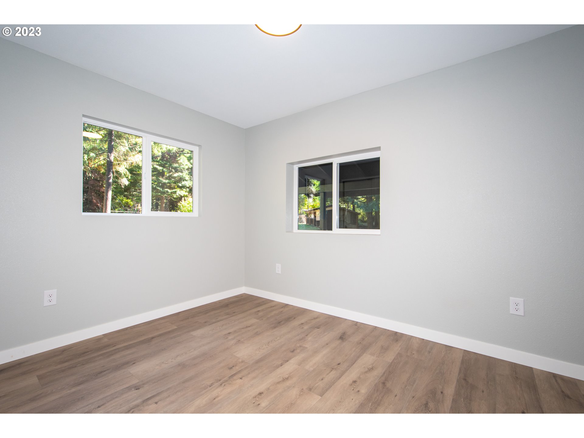 55 Moonshine Road Appleton, WA 98602 - Photo 15 of 33 a view of an empty room with wooden floor and a window