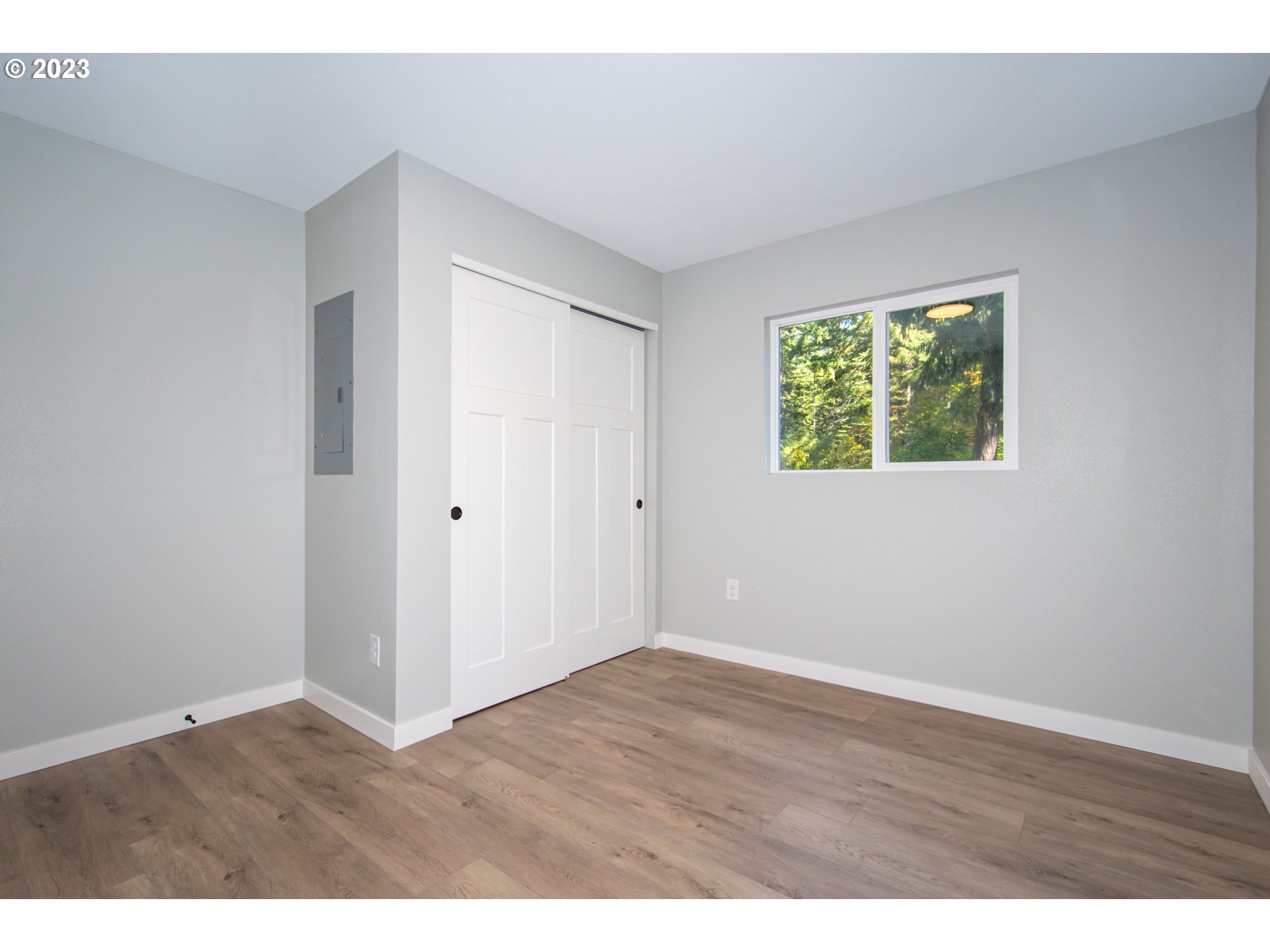 55 Moonshine Road Appleton, WA 98602 - Photo 16 of 33 a view of an empty room with wooden floor and a window
