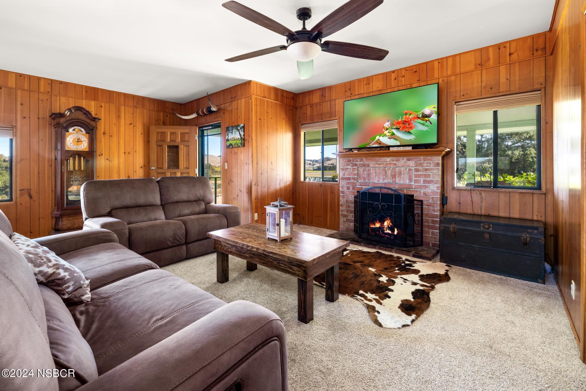 0 Ca Highway Los Alamos, CA 93440 - Photo 69 of 76 a living room with furniture a flat screen tv and a fireplace