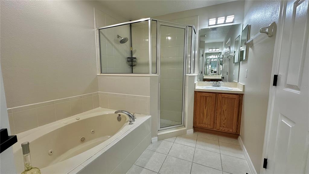 60 Pine Grove Drive Palm Coast, FL 32164 - Photo 11 of 20 a bathroom with a bathtub and a shower