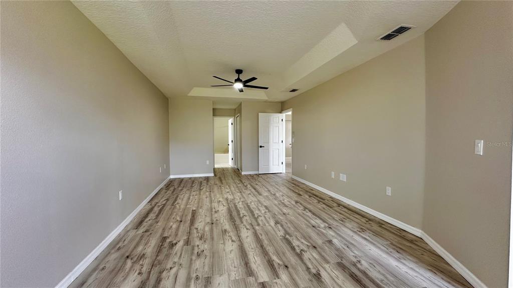 60 Pine Grove Drive Palm Coast, FL 32164 - Photo 13 of 20 wooden floor in an empty room with a window