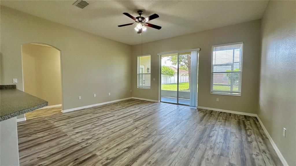 60 Pine Grove Drive Palm Coast, FL 32164 - Photo 16 of 20 wooden floor in an empty room with a window