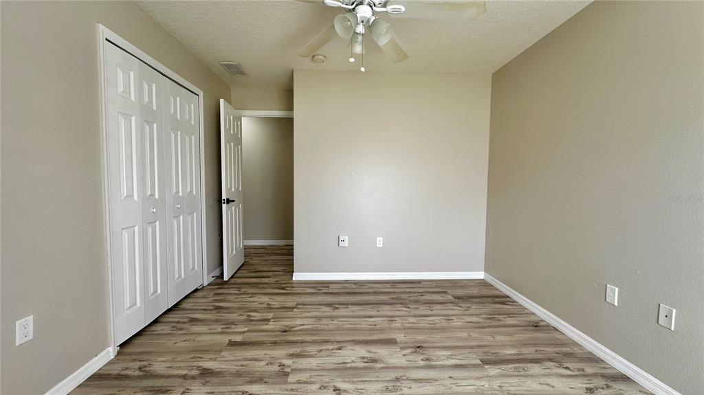 60 Pine Grove Drive Palm Coast, FL 32164 - Photo 3 of 20 wooden floor in an empty room with a window