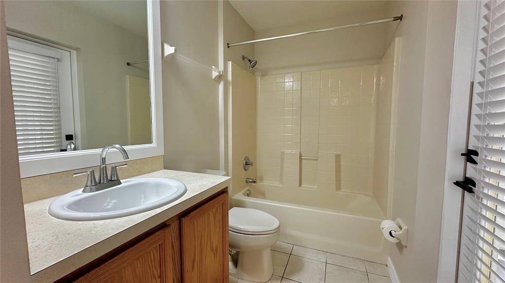 60 Pine Grove Drive Palm Coast, FL 32164 - Photo 5 of 20 a bathroom with a sink a toilet and shower