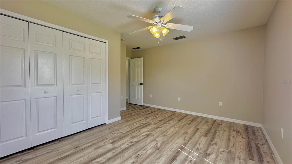 60 Pine Grove Drive Palm Coast, FL 32164 - Photo 6 of 20 a view of an empty room with wooden floor