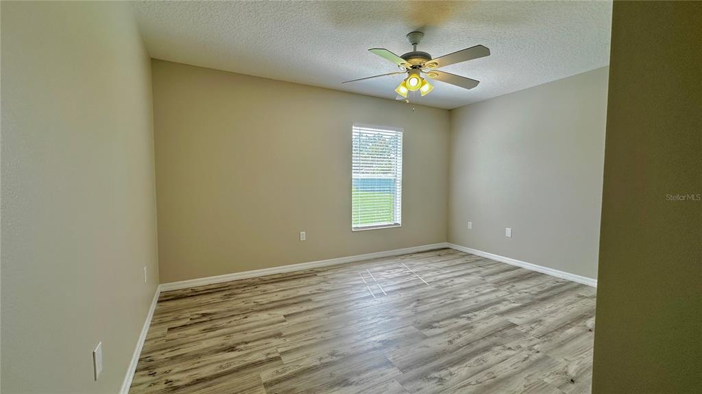60 Pine Grove Drive Palm Coast, FL 32164 - Photo 7 of 20 a view of an empty room with window and wooden floor