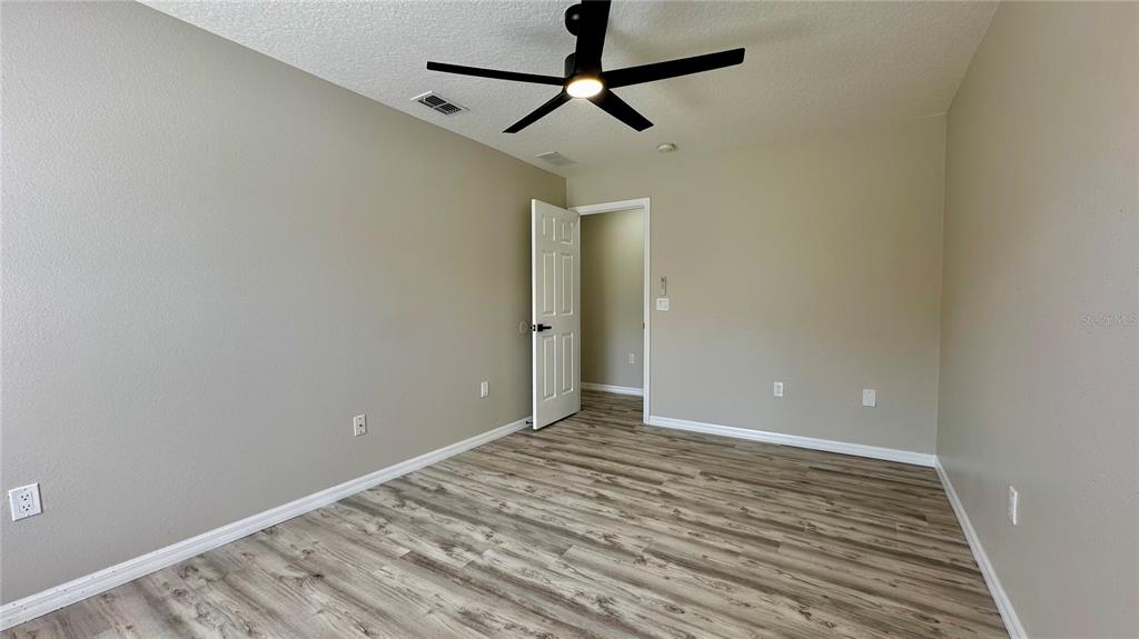 60 Pine Grove Drive Palm Coast, FL 32164 - Photo 8 of 20 a view of room with wooden floor and ceiling fan