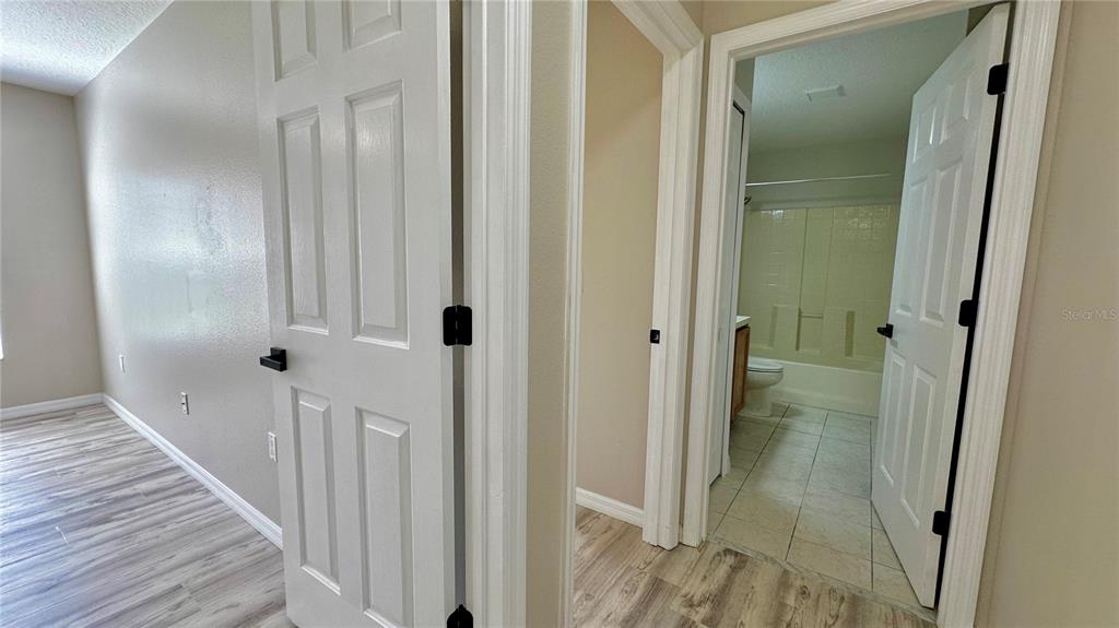 60 Pine Grove Drive Palm Coast, FL 32164 - Photo 10 of 20 a view of a hallway with wooden floor