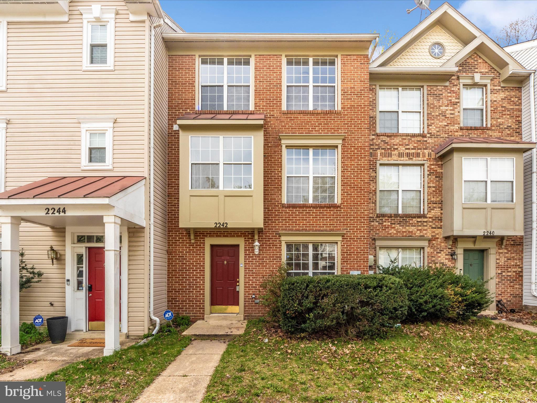 2242 Commissary Circle Odenton, MD 21113 - Photo 1 of 51 a front view of a residential apartment building with a yard
