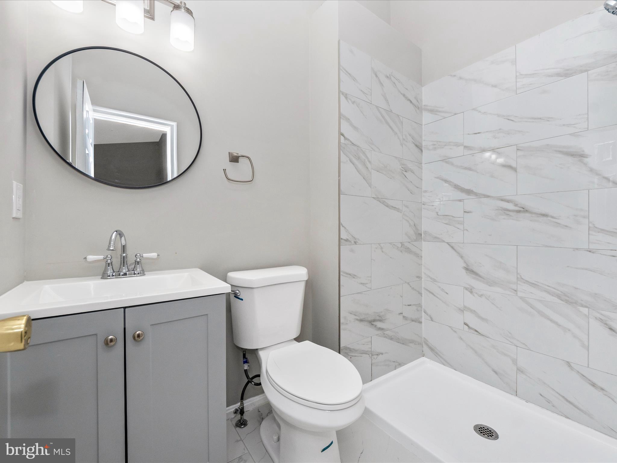 2242 Commissary Circle Odenton, MD 21113 - Photo 28 of 51 a bathroom with a sink a toilet and a mirror