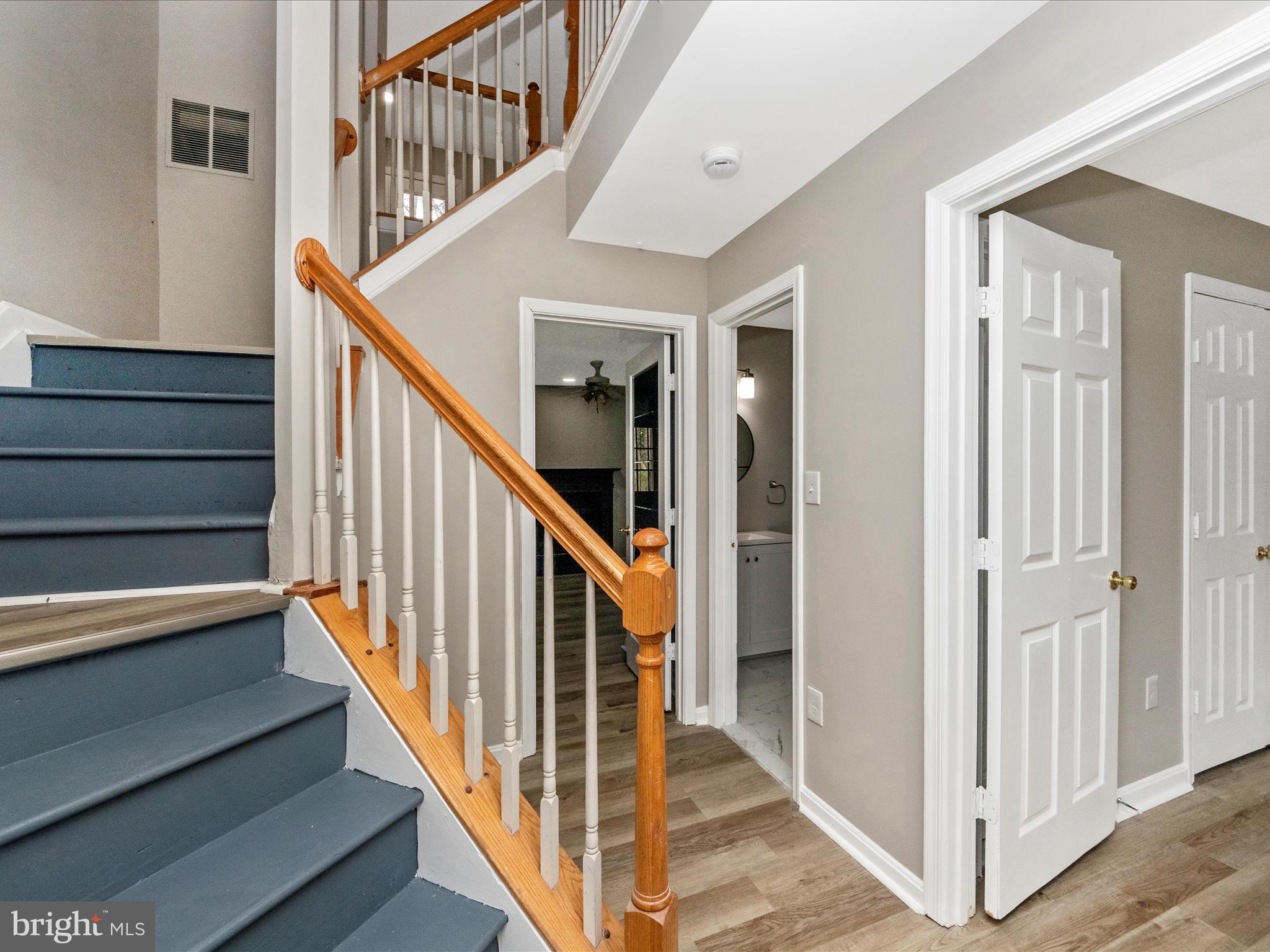 2242 Commissary Circle Odenton, MD 21113 - Photo 3 of 51 a view of staircase with lots of frames on wall and wooden floor