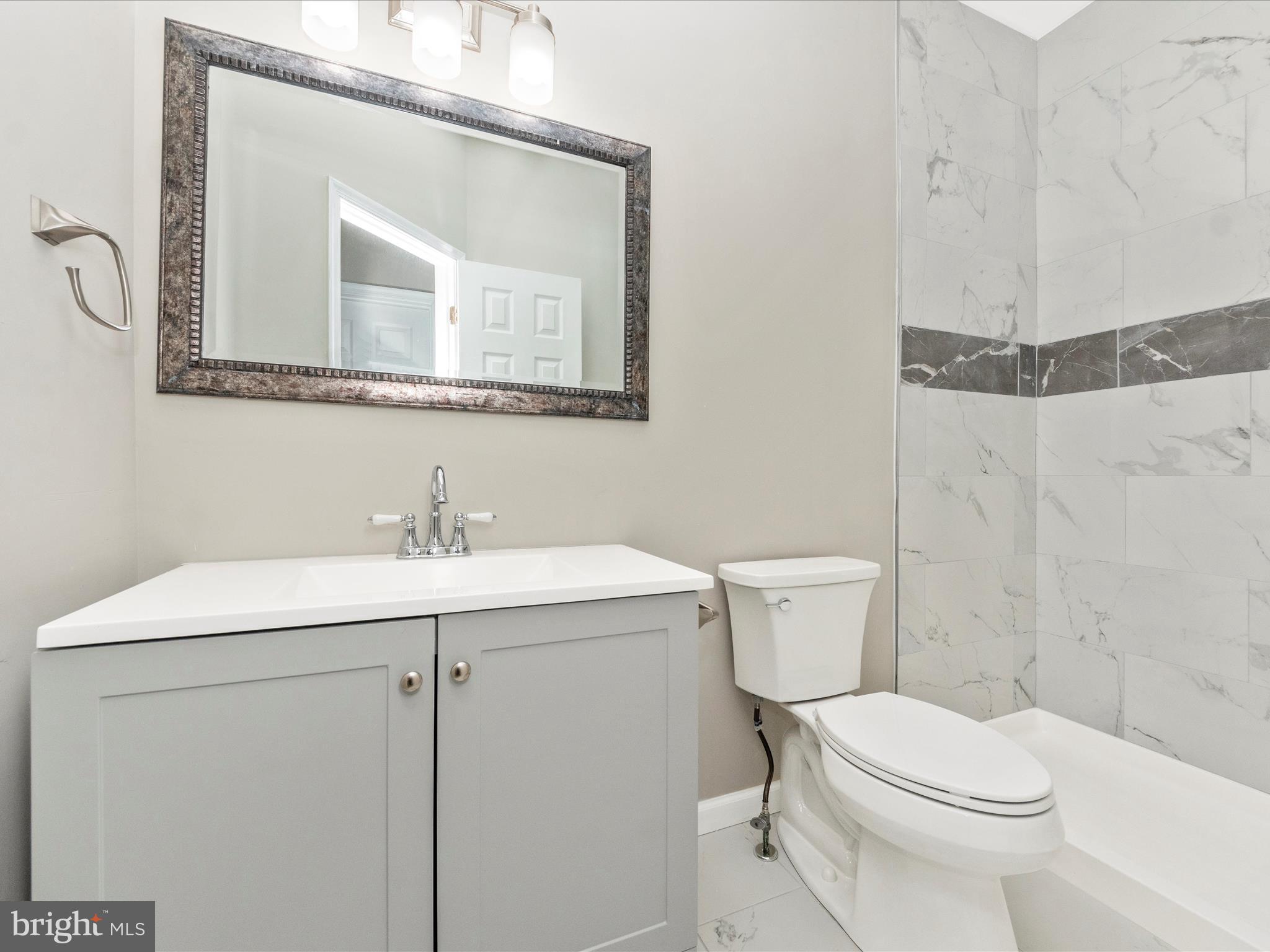 2242 Commissary Circle Odenton, MD 21113 - Photo 36 of 51 a bathroom with a toilet a sink a mirror and vanity