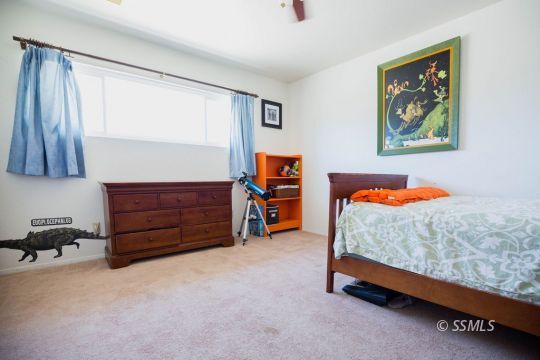 2030 South Inyo Street Ridgecrest, CA 93555 - Photo 26 of 42 a bedroom with a bed and a dresser in it