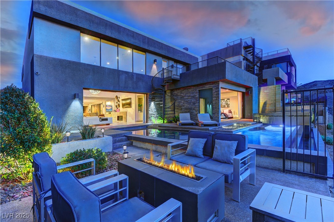 View of patio / terrace featuring a hot tub, grilling area, and an outdoor living space with a fire pit