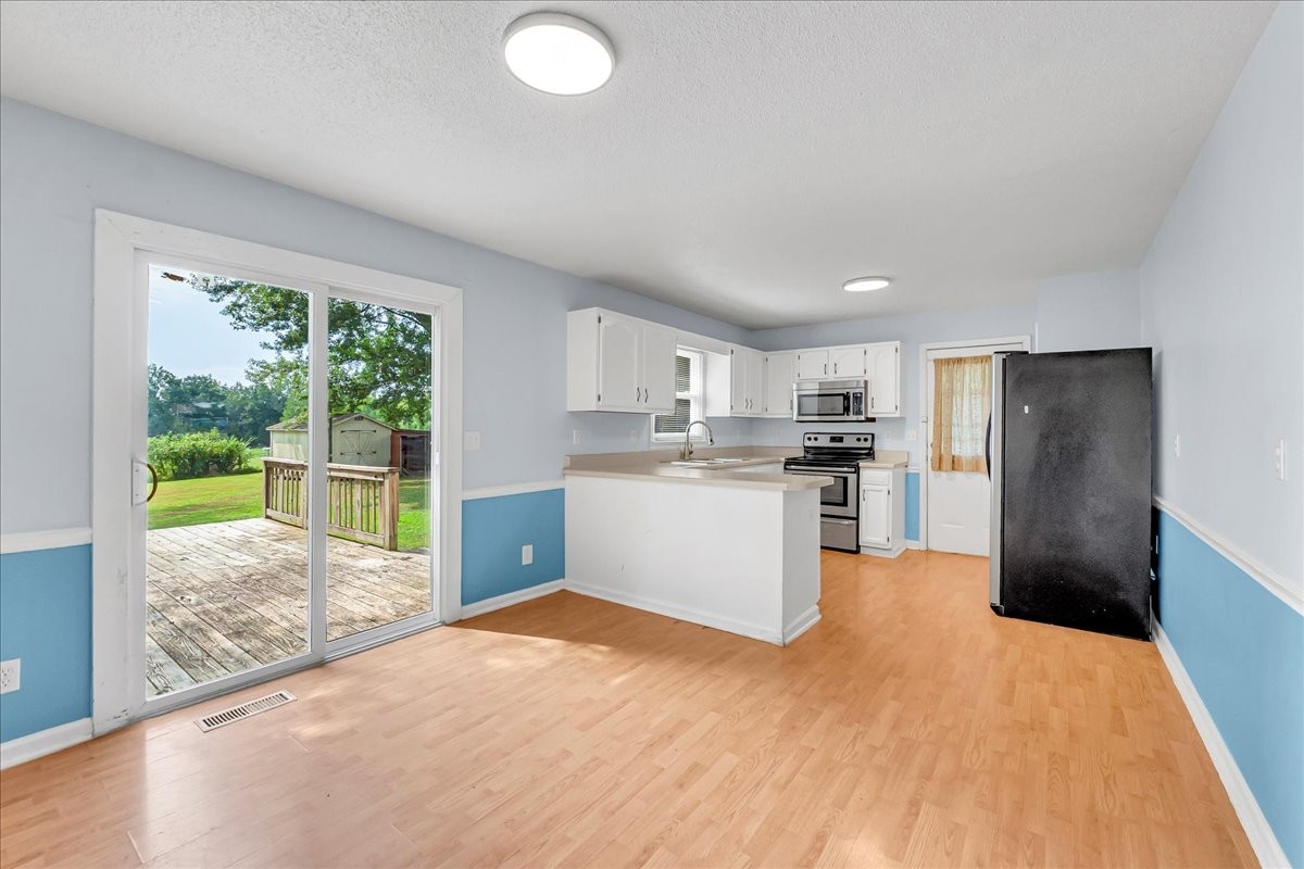 179 Eaton Heights Manchester, TN 37355 - Photo 11 of 33 a kitchen with a refrigerator a sink and a stove top oven