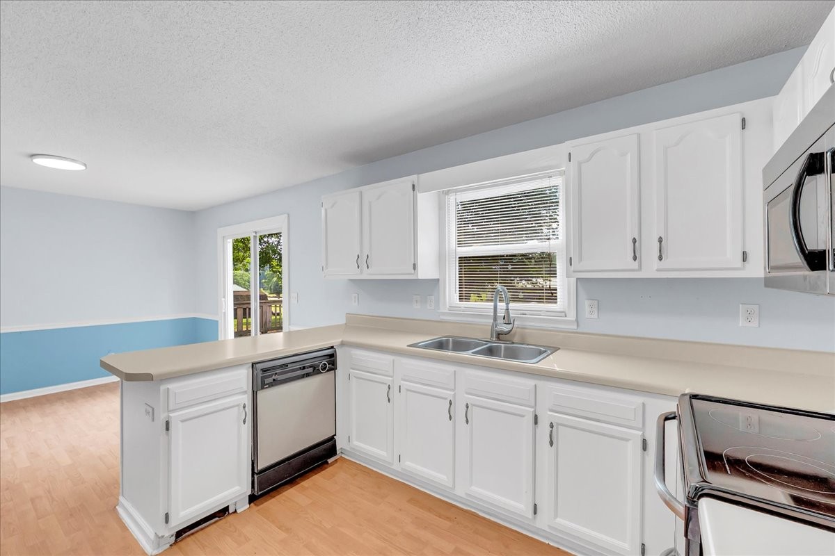 179 Eaton Heights Manchester, TN 37355 - Photo 12 of 33 a kitchen with white cabinets appliances a sink and a window