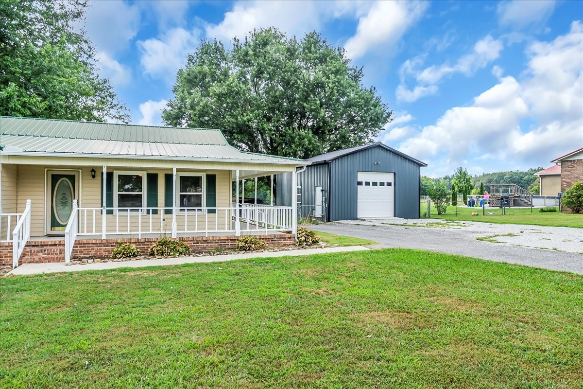 179 Eaton Heights Manchester, TN 37355 - Photo 2 of 33 a front view of a house with a garden and porch