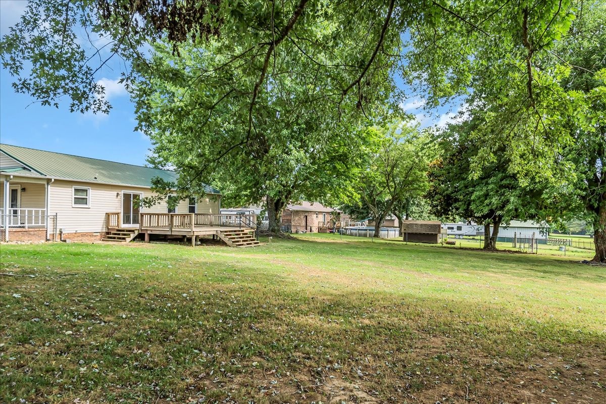 179 Eaton Heights Manchester, TN 37355 - Photo 22 of 33 a yellow house in middle of the forest