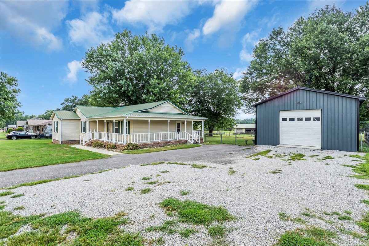 179 Eaton Heights Manchester, TN 37355 - Photo 30 of 33 a front view of a house with a yard and garage