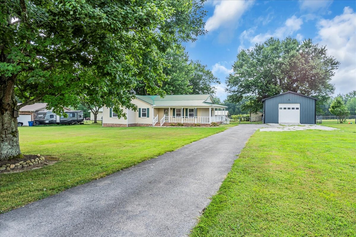 179 Eaton Heights Manchester, TN 37355 - Photo 5 of 33 a view of house with garden and tall trees