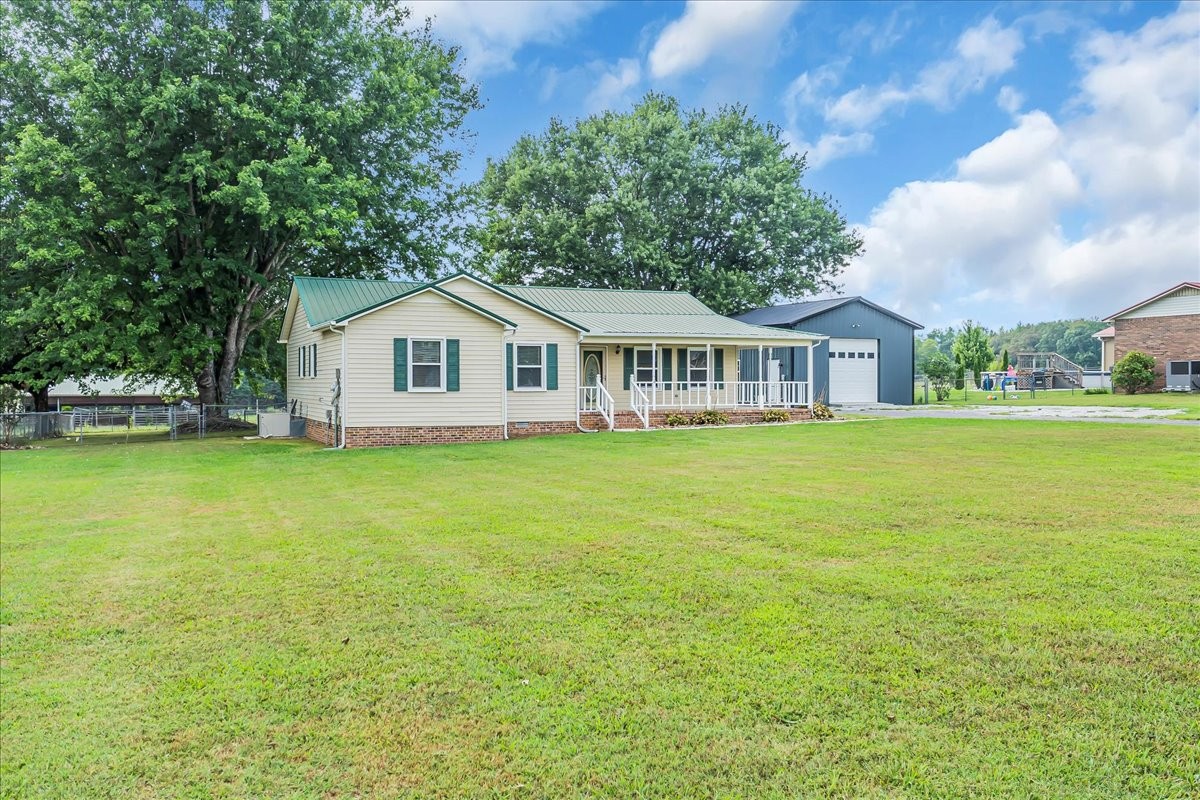 179 Eaton Heights Manchester, TN 37355 - Photo 6 of 33 a view of a house with a big yard and large trees