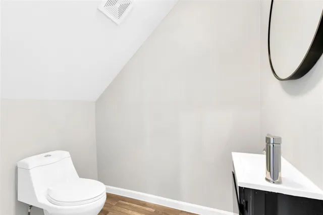 a white toilet sitting next to a bathroom sink