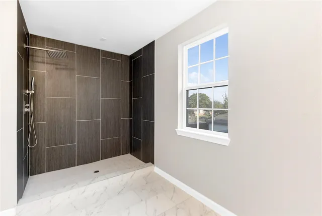 a bathroom with a shower and a window