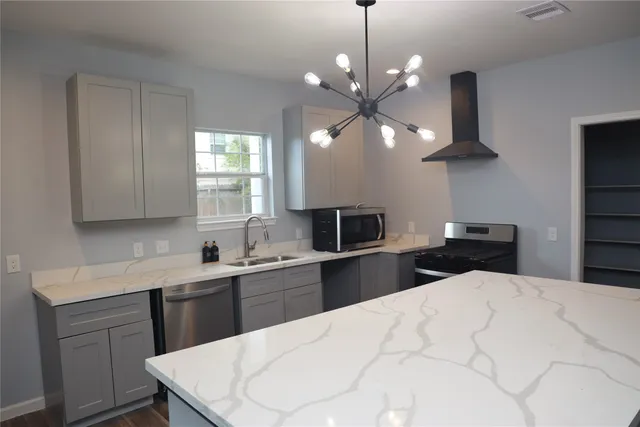 a kitchen with a stove a sink and a refrigerator