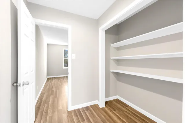 a view of a room with wooden floor