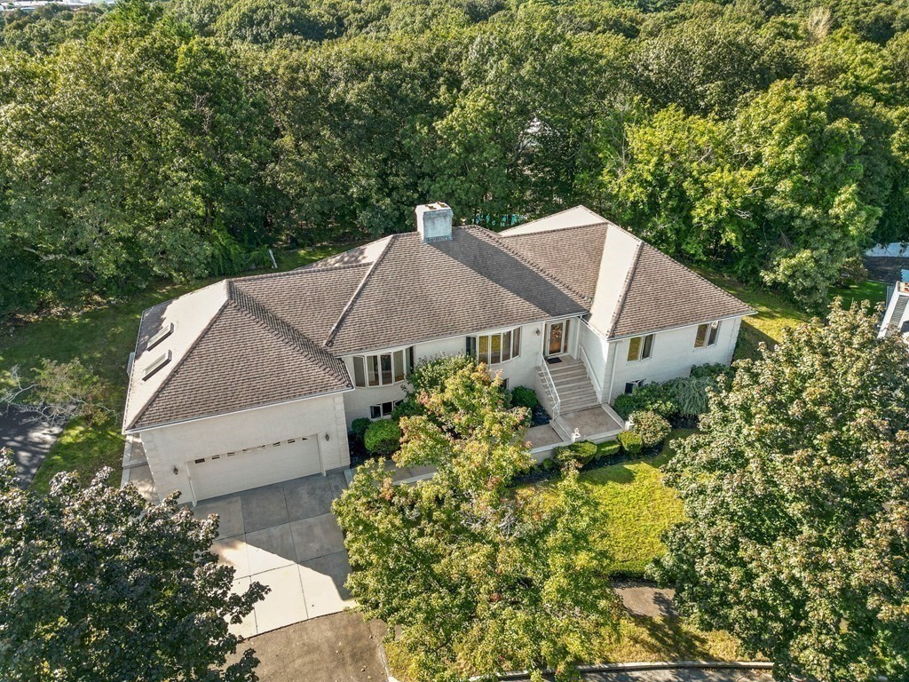 an aerial view of a house with a yard and sitting area