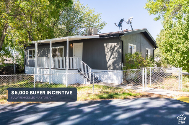 96 Barrington Way Layton, UT 84041 - Photo 1 of 18 Front exterior with a covered porch, white railing, and dark siding