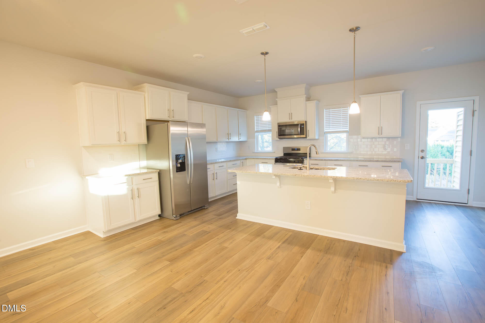 765 Larkspur Bowl Way Apex, NC 27523 - Photo 12 of 25 a view of a kitchen with a sink cabinets and wooden floor