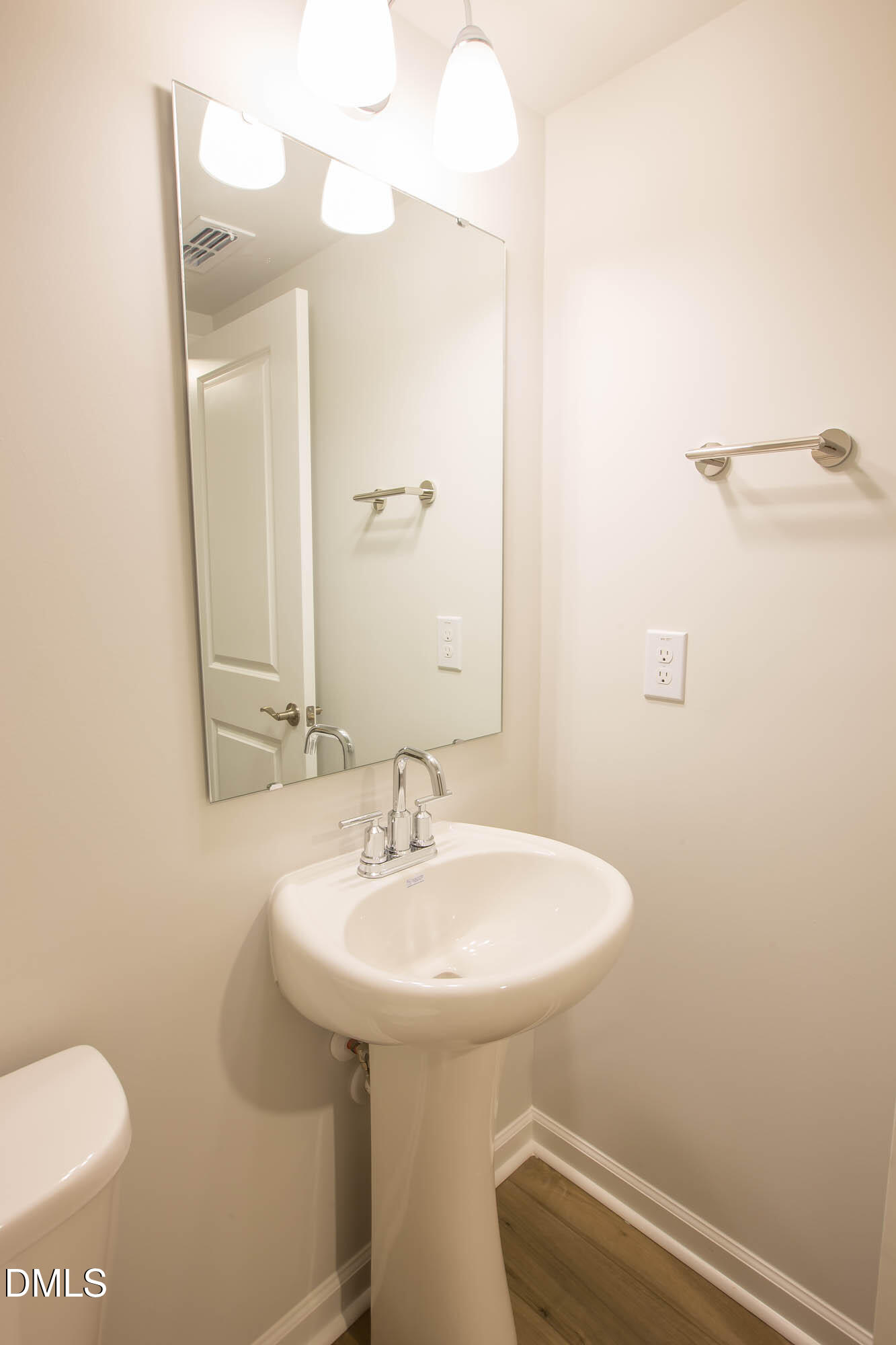 765 Larkspur Bowl Way Apex, NC 27523 - Photo 15 of 25 a bathroom with a sink a toilet and mirror