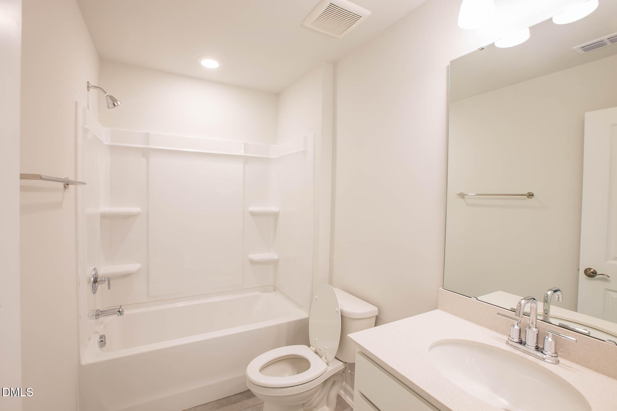 765 Larkspur Bowl Way Apex, NC 27523 - Photo 18 of 25 a bathroom with a bathtub shower sink vanity mirror and toilet