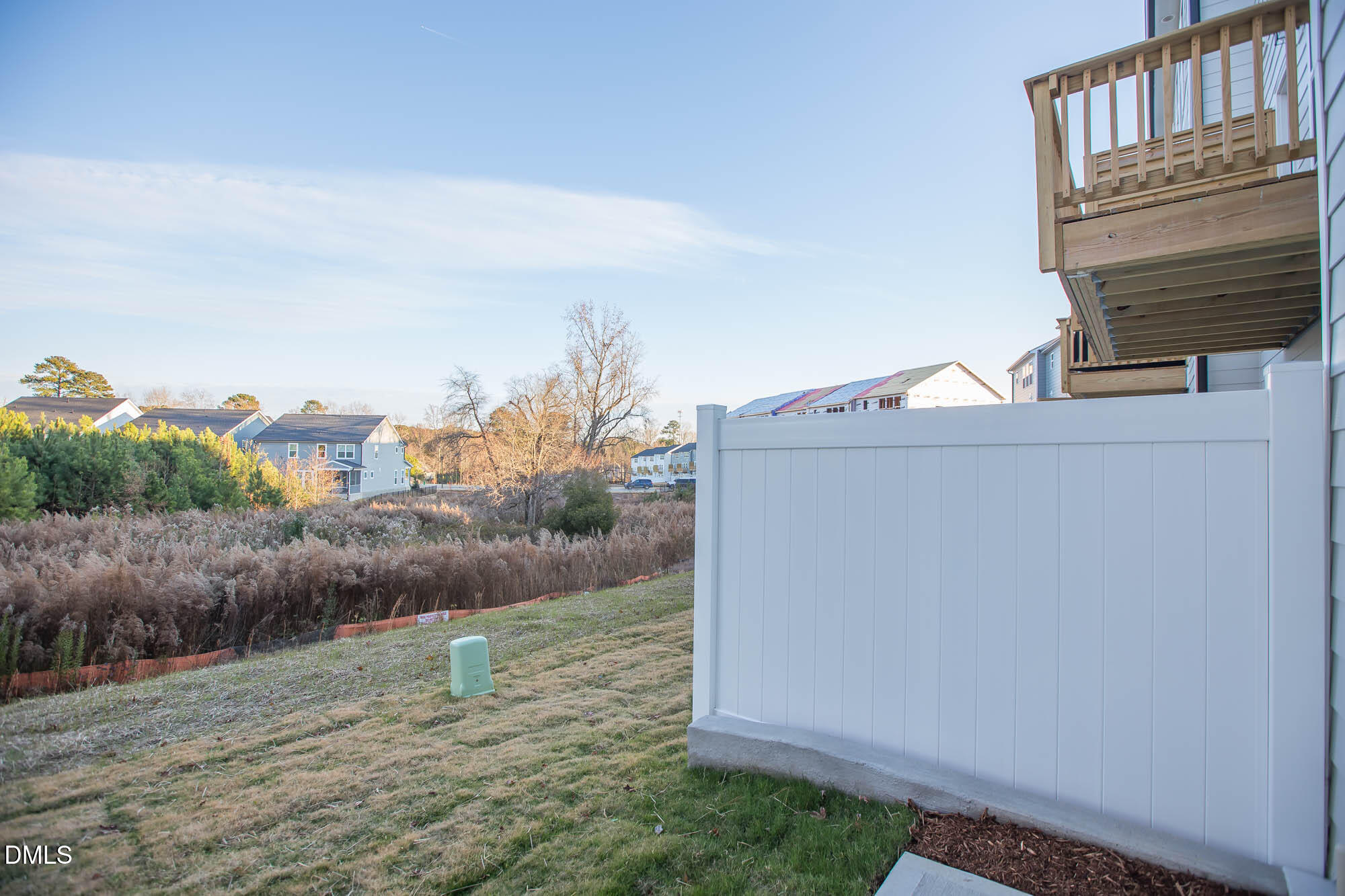765 Larkspur Bowl Way Apex, NC 27523 - Photo 3 of 25 a view of a dry yard with wooden fence