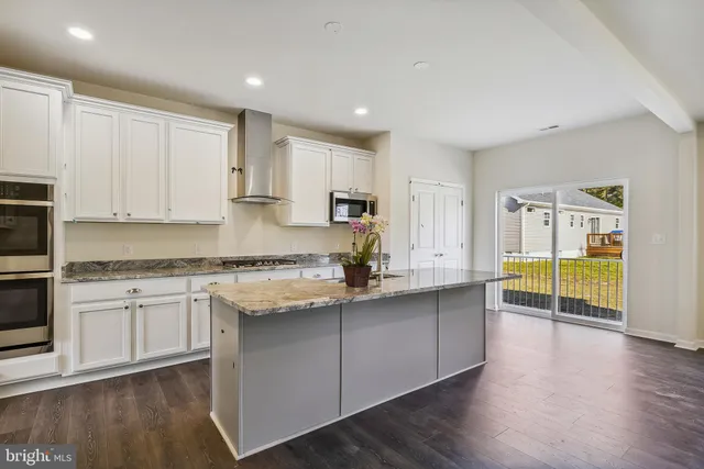 a kitchen with stainless steel appliances granite countertop a sink and cabinets