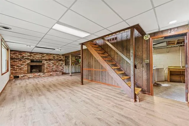 a view of an empty room with a fireplace and a window