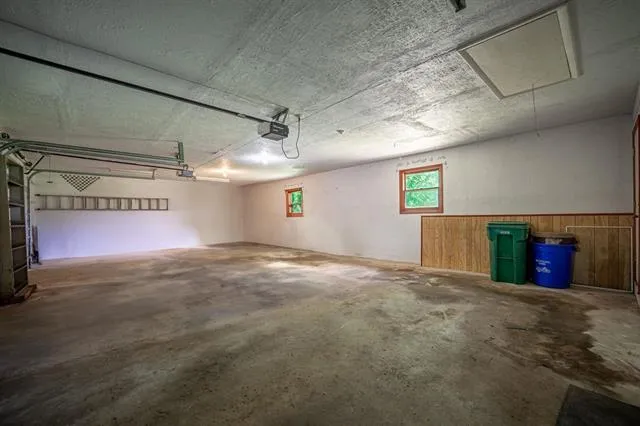a view of a house with a big yard and sitting area