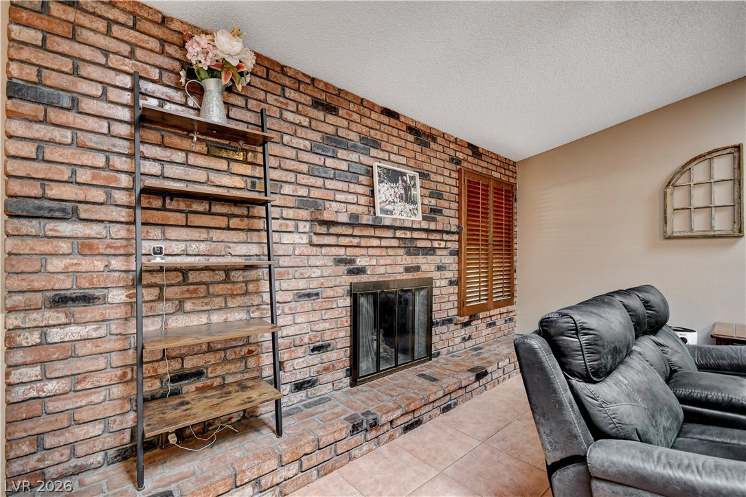 An impressive floor-to-ceiling brick fireplace serves as the focal point of this warm room.