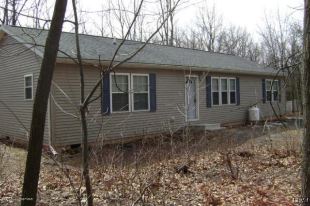 712 Johns Road Effort, PA 18330 - Photo 1 of 6 a front view of a house with trees
