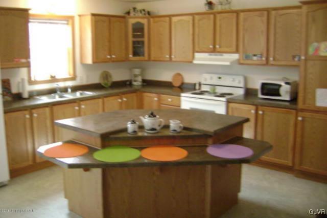 712 Johns Road Effort, PA 18330 - Photo 2 of 6 a kitchen with a sink a stove and a cabinets