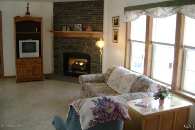 712 Johns Road Effort, PA 18330 - Photo 4 of 6 a living room with furniture and a fireplace