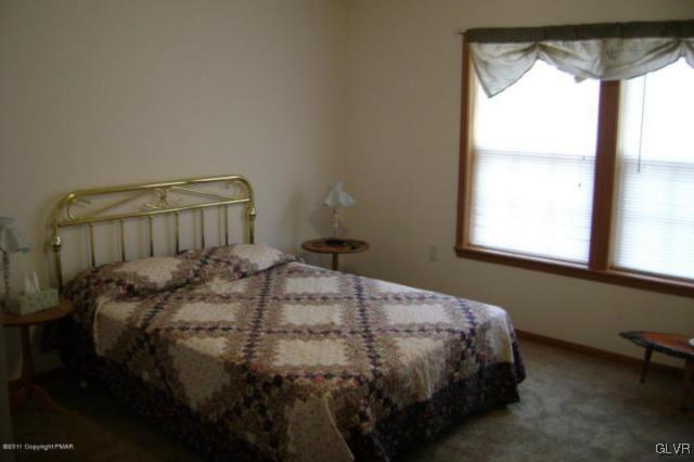 712 Johns Road Effort, PA 18330 - Photo 5 of 6 a bedroom with a bed and a window