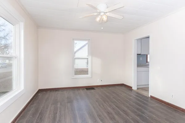 wooden floor in an empty room with a window